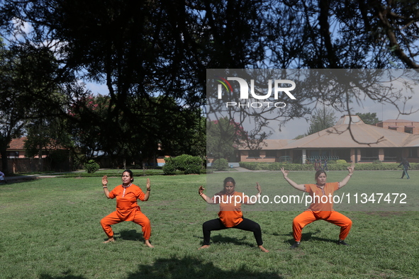 Nepalese people are practicing Yoga at an open ground in Bhaktapur, Nepal, on June 21, 2024, on the occasion of International Yoga Day. 