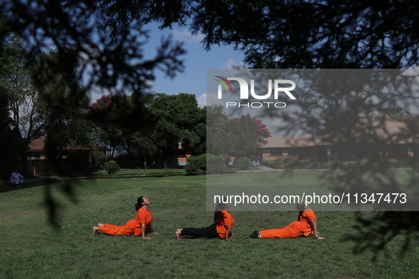 Nepalese people are practicing Yoga at an open ground in Bhaktapur, Nepal, on June 21, 2024, on the occasion of International Yoga Day. 