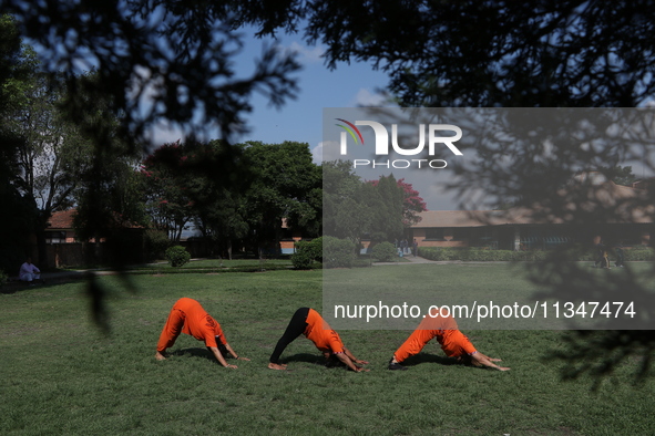 Nepalese people are practicing Yoga at an open ground in Bhaktapur, Nepal, on June 21, 2024, on the occasion of International Yoga Day. 