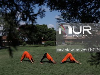 Nepalese people are practicing Yoga at an open ground in Bhaktapur, Nepal, on June 21, 2024, on the occasion of International Yoga Day. (