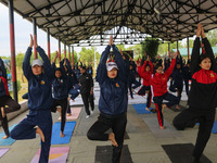 Cadets from the National Cadet Corps (NCC) are performing yoga on International Day of Yoga at Jammu Kashmir Light Infantry Regimental Cente...