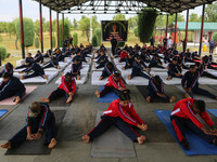 Cadets from the National Cadet Corps (NCC) are performing yoga on International Day of Yoga at Jammu Kashmir Light Infantry Regimental Cente...