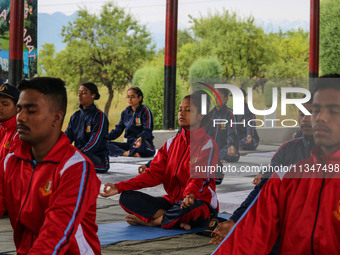 Cadets from the National Cadet Corps (NCC) are performing yoga on International Day of Yoga at Jammu Kashmir Light Infantry Regimental Cente...