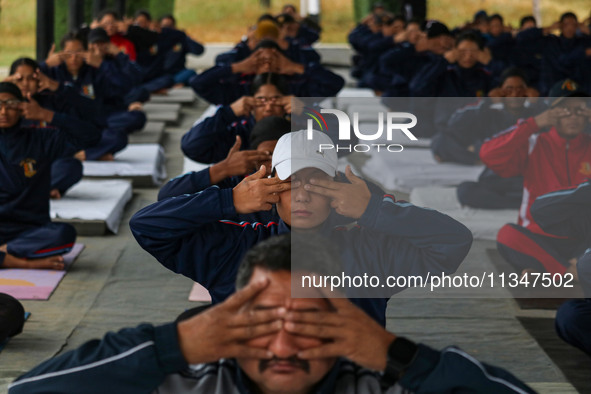 Cadets from the National Cadet Corps (NCC) are performing yoga on International Day of Yoga at Jammu Kashmir Light Infantry Regimental Cente...