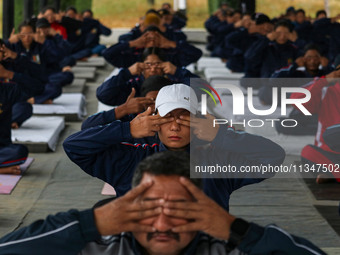 Cadets from the National Cadet Corps (NCC) are performing yoga on International Day of Yoga at Jammu Kashmir Light Infantry Regimental Cente...