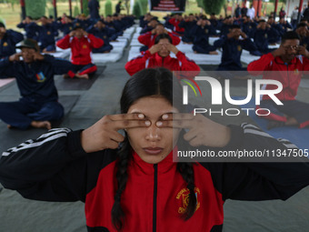 Cadets from the National Cadet Corps (NCC) are performing yoga on International Day of Yoga at Jammu Kashmir Light Infantry Regimental Cente...