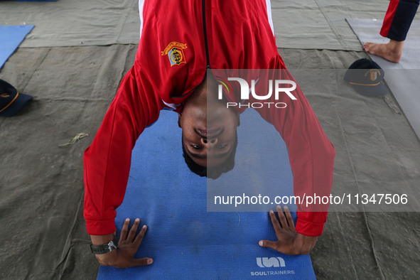 A cadet of the National Cadet Corps (NCC) is performing yoga on International Day of Yoga at Jammu Kashmir Light Infantry Regimental Center...