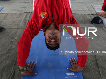 A cadet of the National Cadet Corps (NCC) is performing yoga on International Day of Yoga at Jammu Kashmir Light Infantry Regimental Center...