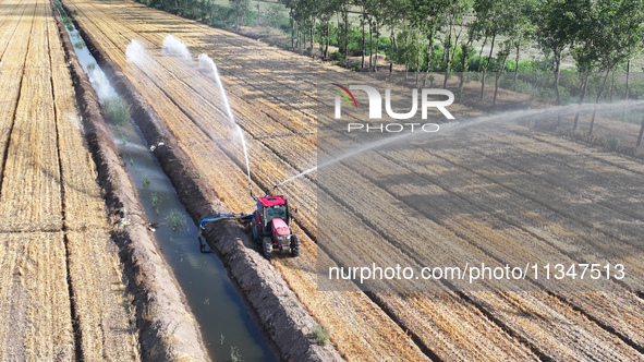 Villagers are carrying out irrigation work in Guangming village, Lianyungang city, East China's Jiangsu province, on June 21, 2024. 