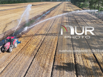 Villagers are carrying out irrigation work in Guangming village, Lianyungang city, East China's Jiangsu province, on June 21, 2024. (