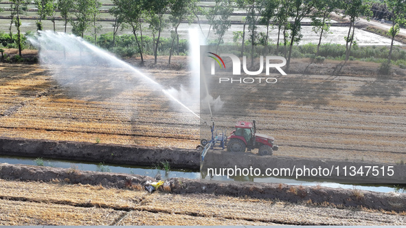 Villagers are carrying out irrigation work in Guangming village, Lianyungang city, East China's Jiangsu province, on June 21, 2024. 