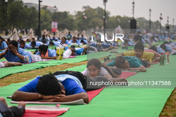 People are performing Yoga on the occasion of International Yoga Day, on the lawns of Kartavya Path, in front of India Gate, in New Delhi, I...