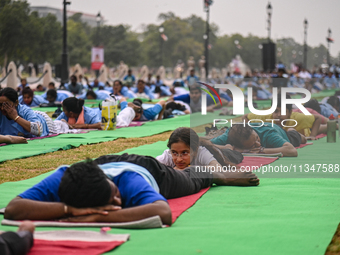 People are performing Yoga on the occasion of International Yoga Day, on the lawns of Kartavya Path, in front of India Gate, in New Delhi, I...