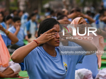 People are performing Yoga on the occasion of International Yoga Day, on the lawns of Kartavya Path, in front of India Gate, in New Delhi, I...