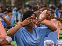 People are performing Yoga on the occasion of International Yoga Day, on the lawns of Kartavya Path, in front of India Gate, in New Delhi, I...