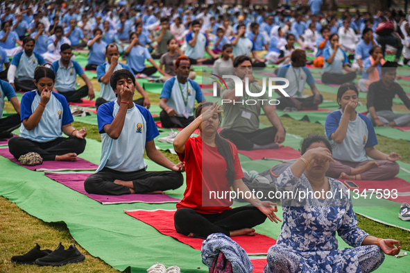 People are performing Yoga on the occasion of International Yoga Day, on the lawns of Kartavya Path, in front of India Gate, in New Delhi, I...