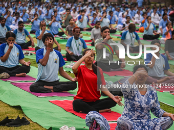 People are performing Yoga on the occasion of International Yoga Day, on the lawns of Kartavya Path, in front of India Gate, in New Delhi, I...