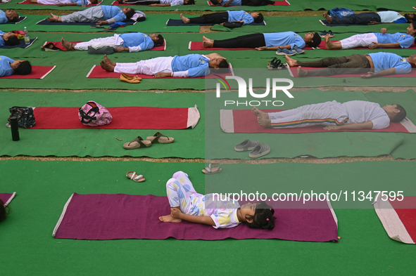 People are performing Yoga on the occasion of International Yoga Day, on the lawns of Kartavya Path, in front of India Gate, in New Delhi, I...