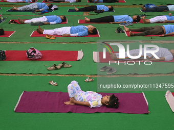 People are performing Yoga on the occasion of International Yoga Day, on the lawns of Kartavya Path, in front of India Gate, in New Delhi, I...