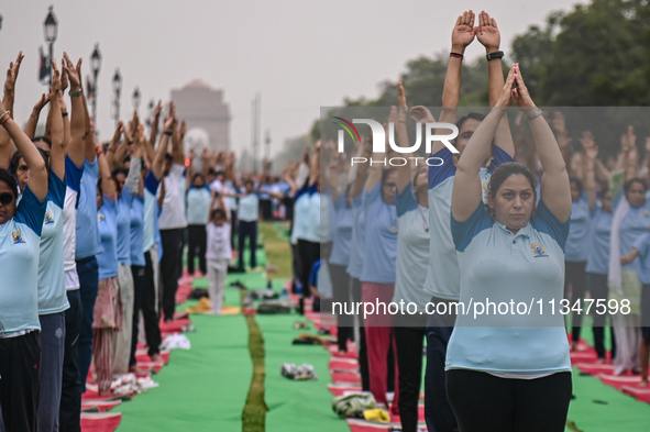 People are performing Yoga on the occasion of International Yoga Day, on the lawns of Kartavya Path, in front of India Gate, in New Delhi, I...