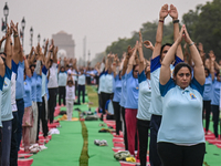 People are performing Yoga on the occasion of International Yoga Day, on the lawns of Kartavya Path, in front of India Gate, in New Delhi, I...