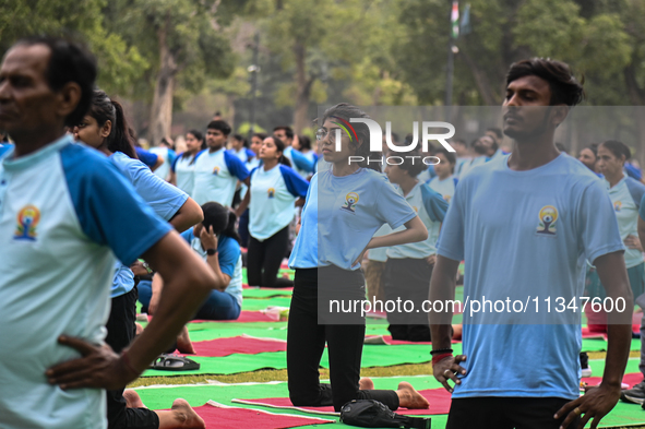 People are performing Yoga on the occasion of International Yoga Day, on the lawns of Kartavya Path, in front of India Gate, in New Delhi, I...