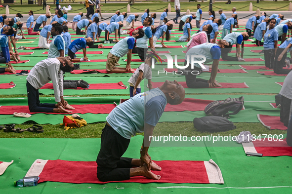 People are performing Yoga on the occasion of International Yoga Day, on the lawns of Kartavya Path, in front of India Gate, in New Delhi, I...