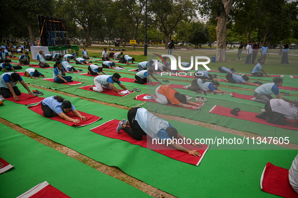 People are performing Yoga on the occasion of International Yoga Day, on the lawns of Kartavya Path, in front of India Gate, in New Delhi, I...