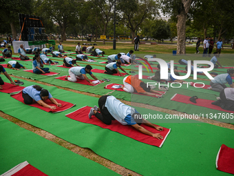 People are performing Yoga on the occasion of International Yoga Day, on the lawns of Kartavya Path, in front of India Gate, in New Delhi, I...