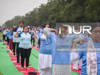 People are performing Yoga on the occasion of International Yoga Day, on the lawns of Kartavya Path, in front of India Gate, in New Delhi, I...