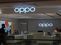 Customers are walking past an OPPO authorized experience store in Shanghai, China, on June 21, 2024. In the first quarter of 2024, Apple is...