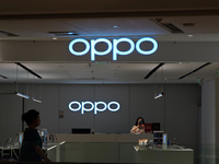 Customers are walking past an OPPO authorized experience store in Shanghai, China, on June 21, 2024. In the first quarter of 2024, Apple is...