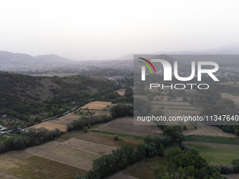 A hazy landscape is seen in an aerial drone view in L’Aquila, Italy, on June 20th, 2024. High atmospheric pressure from Africa (african anti...