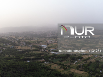 A hazy landscape is seen in an aerial drone view in L’Aquila, Italy, on June 20th, 2024. High atmospheric pressure from Africa (african anti...