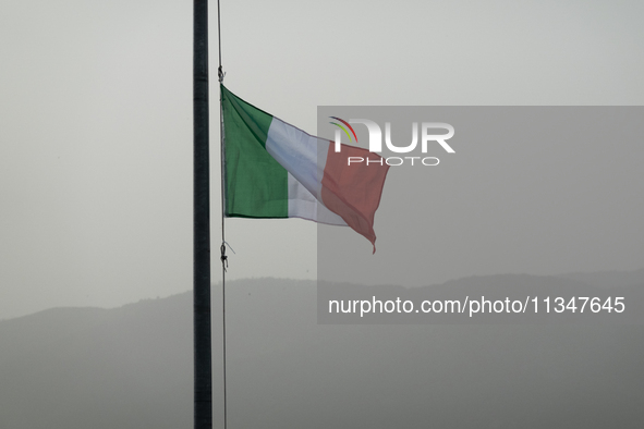 An italian flag and a hazy landscape on background are seen in L’Aquila, Italy, on June 20th, 2024. High atmospheric pressure from Africa (a...