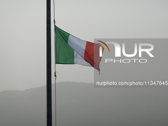 An italian flag and a hazy landscape on background are seen in L’Aquila, Italy, on June 20th, 2024. High atmospheric pressure from Africa (a...