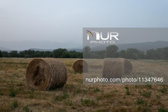 Hay bales are seen in a hazy landscape in L’Aquila, Italy, on June 20th, 2024. High atmospheric pressure from Africa (african anticyclone) i...