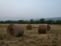 Hay bales are seen in a hazy landscape in L’Aquila, Italy, on June 20th, 2024. High atmospheric pressure from Africa (african anticyclone) i...