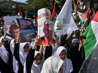 A pro-Palestinian activist is taking part in a protest against Israeli attacks on Gaza and Rafah (refugee camp) with a poster of Benjamin Ne...