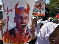 A pro-Palestinian activist is taking part in a protest against Israeli attacks on Gaza and Rafah (refugee camp) with a poster of Benjamin Ne...