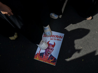 A pro-Palestinian activist is taking part in a protest against Israeli attacks on Gaza and Rafah (refugee camp) with a poster of Benjamin Ne...