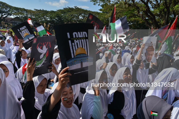 A pro-Palestinian activist is taking part in a protest against Israeli attacks on Gaza and Rafah (refugee camp) with a poster of Benjamin Ne...