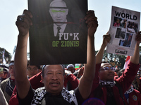 A pro-Palestinian activist is taking part in a protest against Israeli attacks on Gaza and Rafah (refugee camp) with a poster of Benjamin Ne...