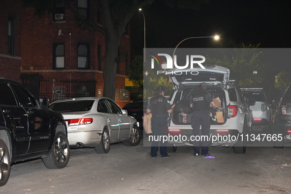 Evidence is being collected at the crime scene. A 50-year-old male victim is being shot multiple times and killed in Chicago, Illinois, Unit...