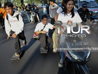 Skaters are taking part in the international world skateboarding day 'Go Skateboarding Day' with a ride around city streets in Malang City,...