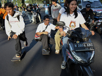 Skaters are taking part in the international world skateboarding day 'Go Skateboarding Day' with a ride around city streets in Malang City,...