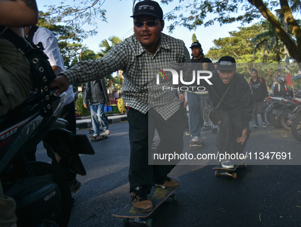 Skaters are taking part in the international world skateboarding day 'Go Skateboarding Day' with a ride around city streets in Malang City,...