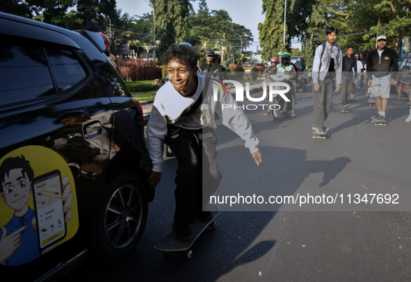 Skaters are taking part in the international world skateboarding day 'Go Skateboarding Day' with a ride around city streets in Malang City,...