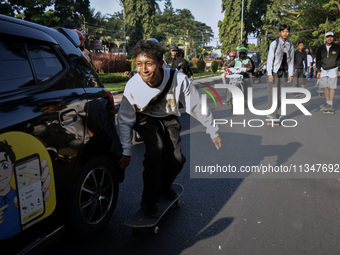 Skaters are taking part in the international world skateboarding day 'Go Skateboarding Day' with a ride around city streets in Malang City,...