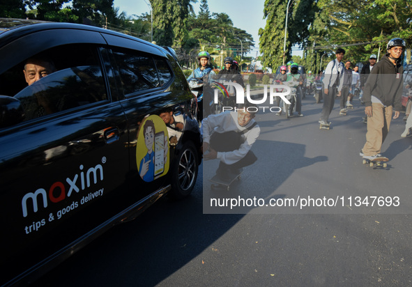 Skaters are taking part in the international world skateboarding day 'Go Skateboarding Day' with a ride around city streets in Malang City,...